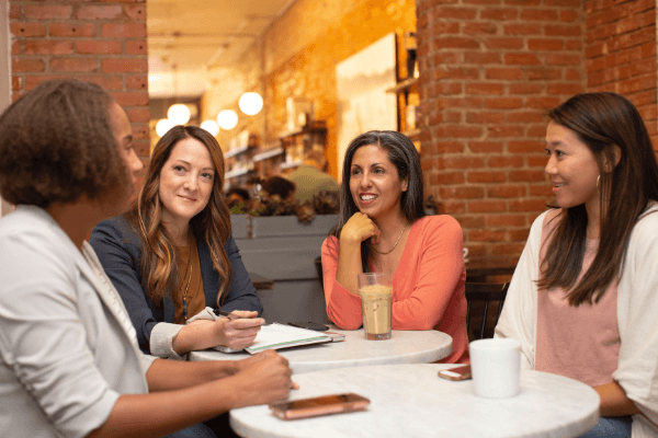 group of women talking at a cafe