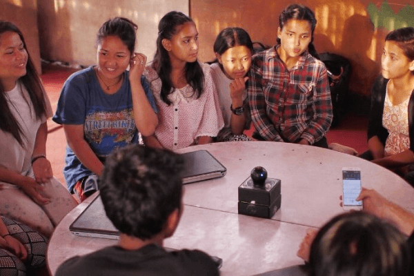 Community of people sitting around a table